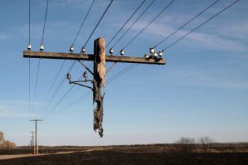 A power line with many wires hanging from it.
